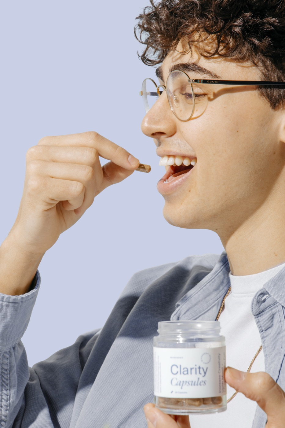 mgx clarity capsule moment - Blog Young person taking a Microgenix Clarity microdose capsule, intentional and clear-headed