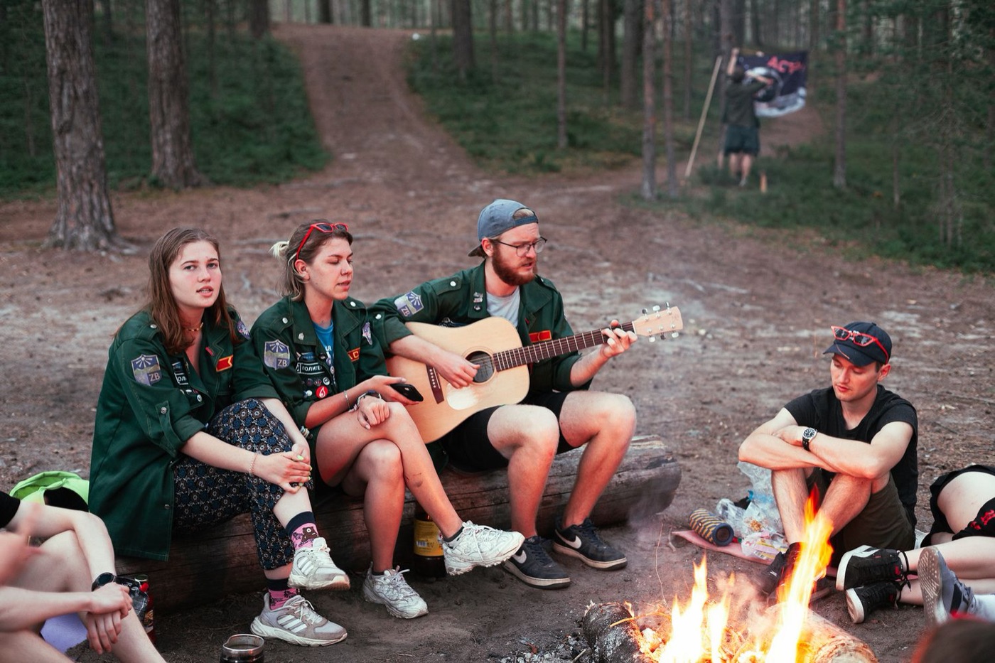 campfire guitar friends - Blog Friends sitting around a campfire in the woods with an acoustic guitar