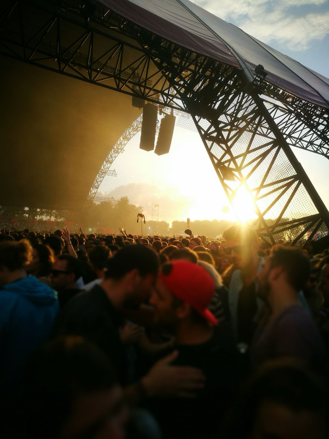 festival stage sunflare - Blog Sunlight flaring through festival stage rigging above a dense crowd