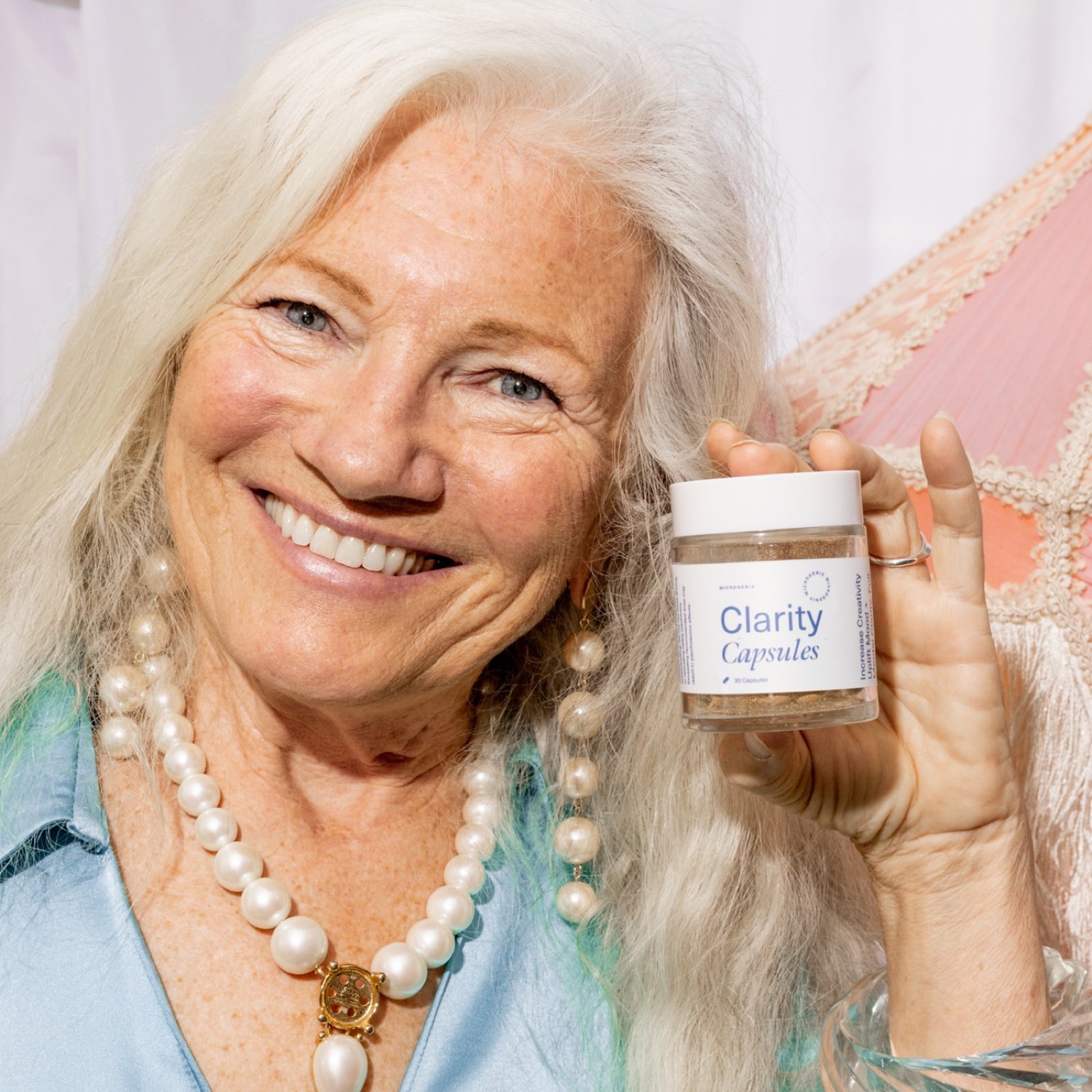 aging woman - Blog An older woman smiling and holding a jar of Microgenix Clarity capsules