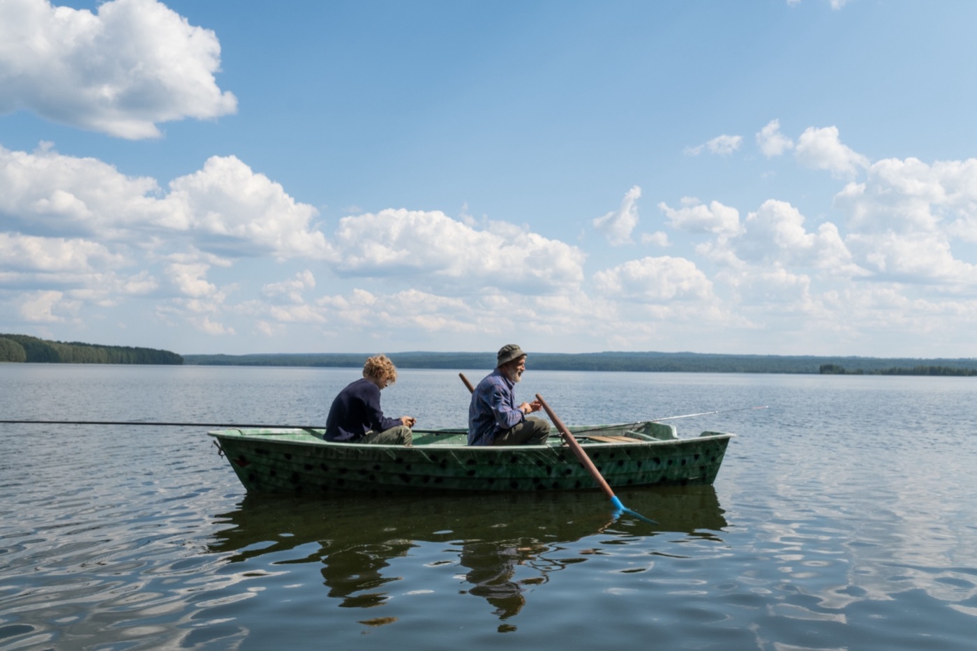 fifty plus grandfather fishing - Blog A grey bearded grandfather and his grandson fishing from a small green rowboat on a calm summer lake