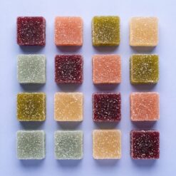 magic gummies flavor grid - Grid of sugared Magic Gummies cubes in wine, coral, olive, amber and sage