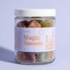 Microgenix Magic Gummies jar, five flavors of sugared gummy cubes behind a periwinkle label
