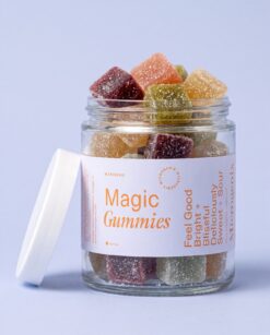 magic gummies open jar - Open Magic Gummies jar with the white lid beside it and mixed flavors filling the glass